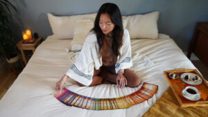woman displaying manifestation cards on bed